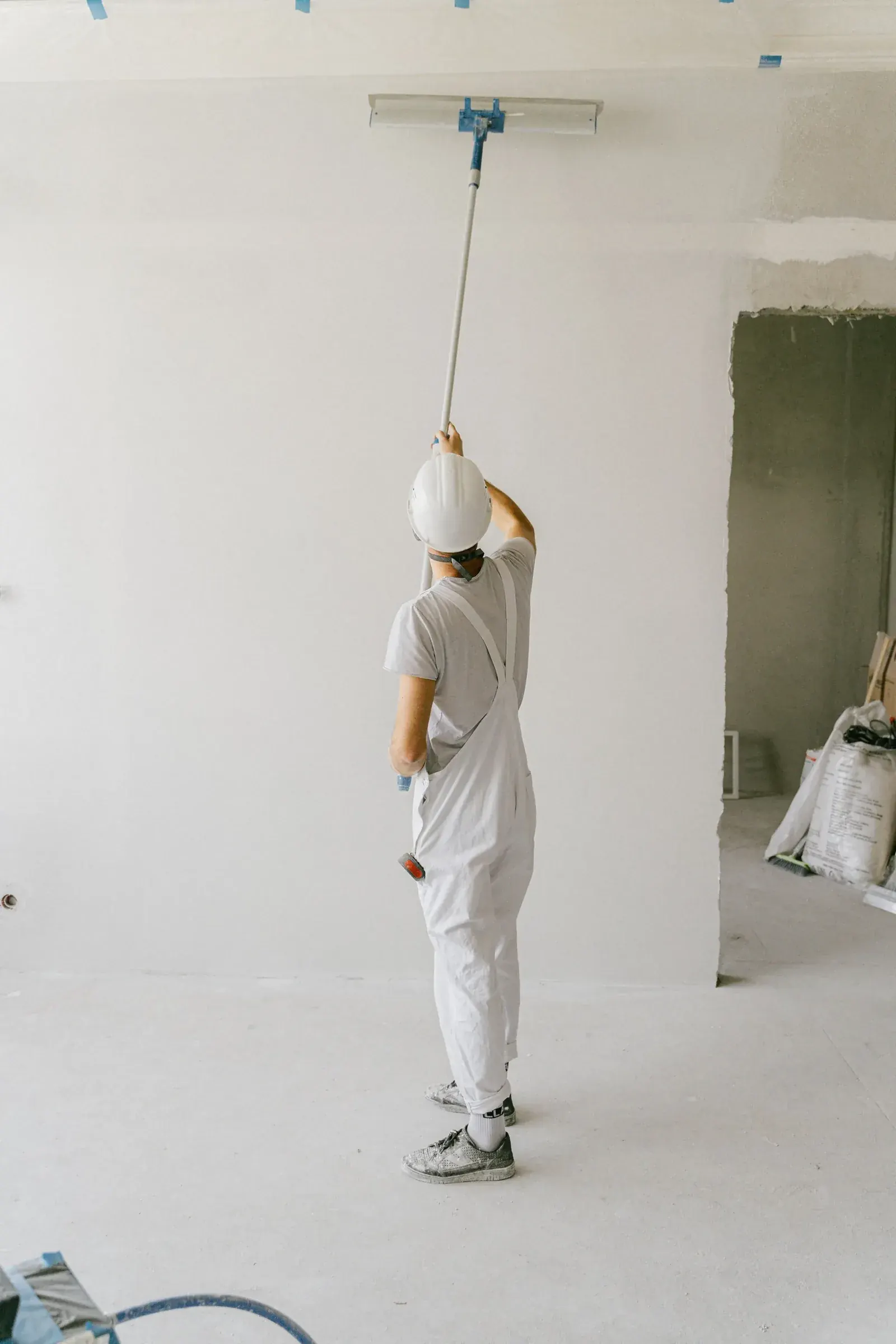 Painter rolling a fresh coat on an interior wall