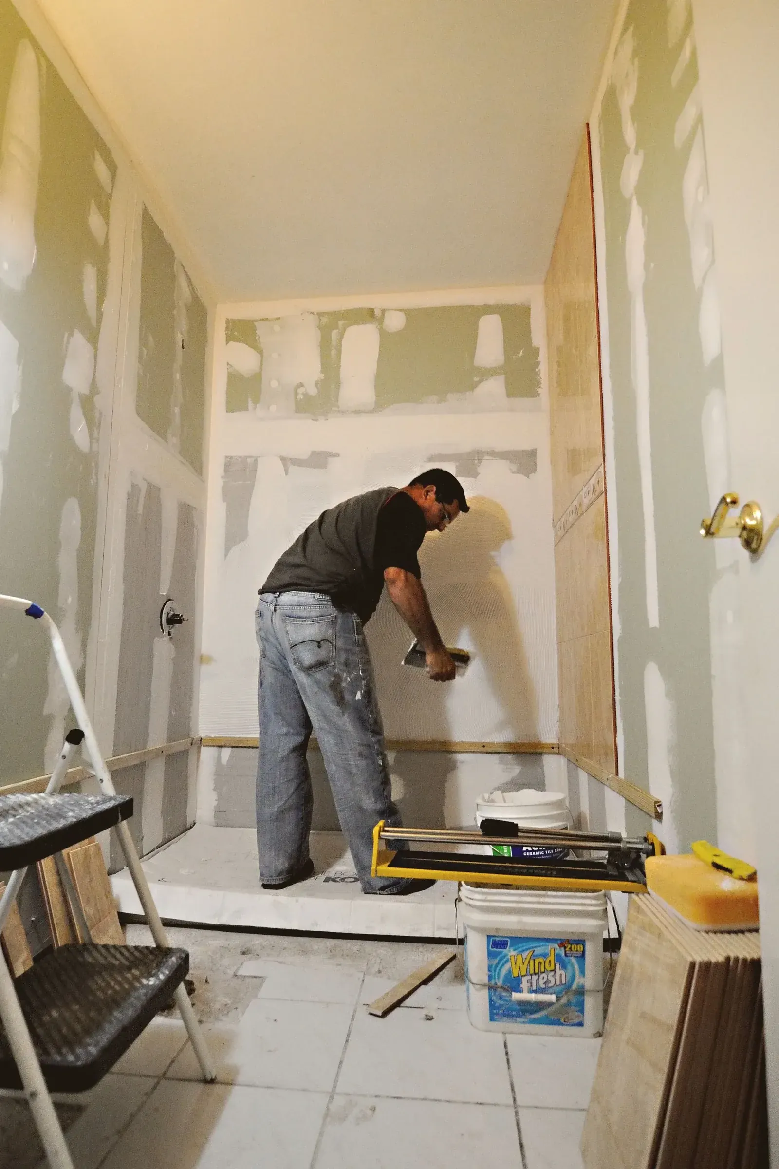 Bathroom renovation in progress with new drywall being finished